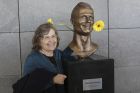 A woman poses next to the bust of Cristiano Ronaldo at the Madeira international airport outside Funchal, the capital of Madeira island, Portugal, Wednesday March 29, 2017. Madeira International Airport has been renamed after local soccer star Cristiano Ronaldo on Wednesday during a ceremony, with family, at the airport outside his Funchal hometown. (AP Photo/Armando Franca)