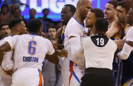 From left, Oklahoma City Thunder guard Russell Westbrook and guard Semaj Christon (6), Golden State Warriors forward Draymond Green, Thunder forward Taj Gibson, and Warriors guards Stephen Curry and Klay Thompson get into a tussle during the second quarter of an NBA basketball game in Oklahoma City, Monday, March 20, 2017. At right are Warriors center Zaza Pachulia and Thunder guard Victor Oladipo. (AP Photo/Sue Ogrocki)