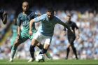 Manchester City's Ilkay Gundogan, right, fights for the ball with Tottenham's Lucas Moura during the English Premier League soccer match between Manchester City and Tottenham Hotspur at Etihad stadium in Manchester, England, Saturday, April 20, 2019. (AP Photo/Rui Vieira)