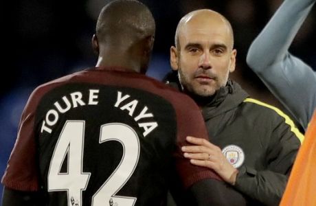 Manchester City's Yaya Toure, who scored both their goals, celebrates with his head coach Pep Guardiola after the English Premier League soccer match between Crystal Palace and Manchester City at Selhurst Park stadium in London, Saturday, Nov. 19, 2016. (AP Photo/Matt Dunham)