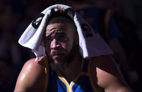 Golden State Warriors' JaVale McGee looks on from the bench during the first half of an NBA basketball game against the Philadelphia 76ers, Monday, Feb. 27, 2017, in Philadelphia. The Warriors won 119-108. (AP Photo/Chris Szagola)