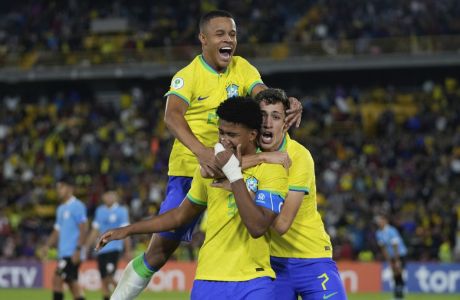 Brazil's Andrey Dos Santos, center, celebrates with teammates after scoring his side's opening goal against Uruguay during a South America U-20 soccer match in Bogota, Colombia, Sunday, Feb. 12, 2023. (AP Photo/Fernando Vergara)