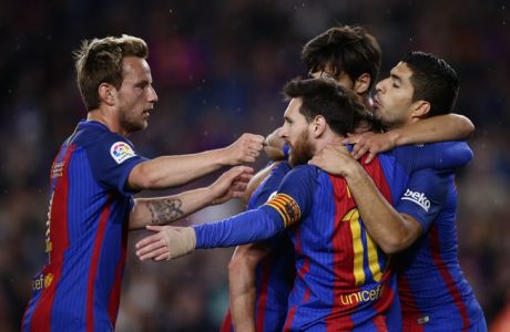FC Barcelona's Lionel Messi, center, celebrates with his teammates after scoring during the Spanish La Liga soccer match between FC Barcelona and Real Sociedad at the Camp Nou stadium in Barcelona, Spain, Saturday, April 15, 2017. (AP Photo/Manu Fernandez)