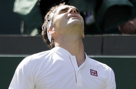 Switzerland's Roger Federer grimaces after losing a point during the fifth set of his men's quarterfinals match against Kevin Anderson of South Africa at the Wimbledon Tennis Championships, in London, Wednesday July 11, 2018. (AP Photo/Ben Curtis)