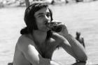 ** FILE ** Former Manchester United and Northern Ireland soccer star George Best sits on the beach at Marbella, Spain, in this May 25, 1972 file photo. Soccer great Best is "desperately ill" but hanging on for survival, his doctor said Monday, Nov. 21, 2005. The 59-year-old Best, who needed a liver transplant three years ago after decades of alcohol abuse, is on life support in stable but critical condition at Cromwell Hospital in west London. (AP Photo) ** B/W ONLY **