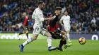 Real Madrid's Daniel Carvajal, left, duels for the ball with Rayo Vallecano's Alex Moreno during the Spanish La Liga soccer match between Real Madrid and Rayo Vallecano at the Bernabeu stadium in Madrid, Spain, Saturday, Dec. 15, 2018. (AP Photo/Manu Fernandez)