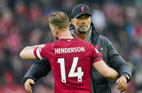 Liverpool's Jordan Henderson, front, hugs with Liverpool's manager Jurgen Klopp at the end of the English Premier League soccer match between Liverpool and Arsenal at Anfield in Liverpool, England, Sunday, April 9, 2023. (AP Photo/Jon Super)