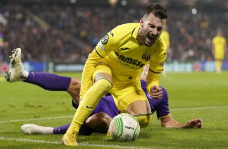 Villarreal's Alex Baena, front, reacts after a tackle by Austria Wien's Reinhold Ranftl, rear, during the Group C Conference League soccer match between Austria Wien and Villarreal in Vienna, Austria, Thursday Oct.13, 2022. (AP Photo/Florian Schroetter)