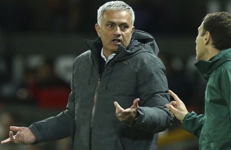 Manchester United's manager Jose Mourinho, left, reacts as he is spoken to by Spanish fourth official Roberto Alonso during the Europa League quarterfinal second leg soccer match between Manchester United and Anderlecht at Old Trafford stadium, in Manchester, England, Thursday, April 20, 2017. (AP Photo/Dave Thompson)