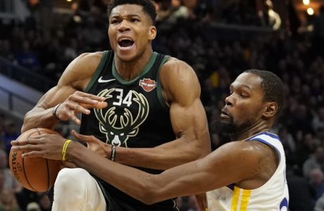 Golden State Warriors' Kevin Durant fouls Milwaukee Bucks' Giannis Antetokounmpo during the second half of an NBA basketball game Friday, Dec. 7, 2018, in Milwaukee. The Warriors won 105-95. (AP Photo/Morry Gash)