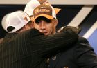 Kellen Winslow, a tight end from Miami, gets a hug from an unidentified man after being selected by the Cleveland Browns in the first round, sixth overall, in the NFL draft Saturday, April 24, 2004 in New York. (AP Photo/John Marshall Mantel)