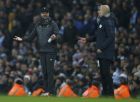Liverpool's coach Juergen Klopp, left, and Manchester City's coach Pep Guardiola gesture from the side line during the English Premier League soccer match between Manchester City and Liverpool at the Etihad Stadium in Manchester, England, Thursday, Jan. 3, 2019.(AP Photo/Dave Thompson)