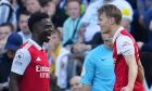 Arsenal's Martin Odegaard, right, celebrates with Bukayo Saka after scoring the opening goal during an English Premier League soccer match between Newcastle and Arsenal at St James' Park stadium in Newcastle, Sunday, May 7, 2023. (AP Photo/Jon Super)