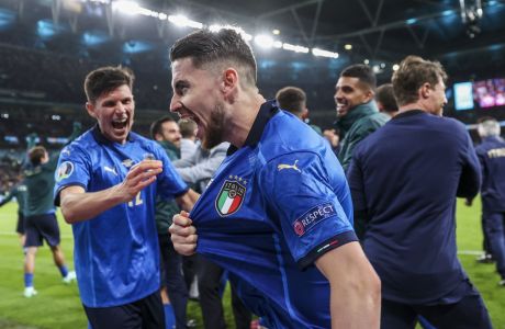 Italy's Jorginho, foreground, celebrates after scoring the last penalty kick and winning the the Euro 2020 soccer championship semifinal match against Spain at Wembley stadium in London, England, Tuesday, July 6, 2021. (Justin Tallis/Pool Photo via AP)