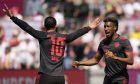 Bayern's Kingsley Coman, right, celebrates after scoring his side's opening goal besides team mate Leroy Sane during the German Bundesliga soccer match between 1. FC Cologne and FC Bayern Munich in Cologne, Germany, Saturday, May 27, 2023. (AP Photo/Matthias Schrader)