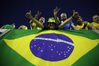 Brazil fans cheer for their team while holding a national flag, prior a 2018 World Cup qualifying soccer match against Uruguay in Montevideo, Uruguay, Thursday, March. 23, 2017. (AP Photo/Natacha Pisarenko)