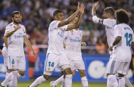 Real Madrid's Carlos E. Casemiro, center, is congratulated by teammates after scoring a goal during a Spanish La Liga soccer match between Deportivo and Real Madrid at the Riazor stadium in Coruna, Spain, Sunday, Aug. 20, 2017. (AP Photo/Lalo R. Villar)