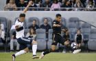 Los Angeles FC defender Mohamed El-Munir, right, centers a pass against Vancouver Whitecaps defender Jake Nerwinski during the first half of a Major League Soccer game in Los Angeles, Saturday, July 6, 2019. (AP Photo/Alex Gallardo)