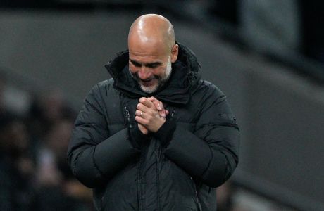 Manchester City's head coach Pep Guardiola reacts after the English FA Cup fourth round soccer match between Tottenham Hotspur and Manchester City in London, Friday, Jan. 26, 2024. Man City win the match 1-0. (AP Photo/Dave Shopland)