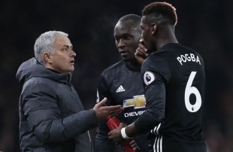 Manchester United coach Jose Mourinho talks with Manchester United's Paul Pogba, right, during the English Premier League soccer match between Arsenal and Manchester United at the Emirates stadium in London, Saturday, Dec. 2, 2017. (AP Photo/Kirsty Wigglesworth)
