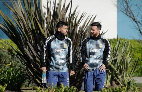 Sergio Aguero, left, and Lionel Messi attend a training session with the Argentine national soccer squad in Buenos Aires, Argentina, Wednesday, May 23, 2018. Argentina will face Haiti on May 29 in an international friendly soccer match ahead of the FIFA Russia World Cup. (AP Photo/Victor R. Caivano)
