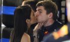 Red Bull driver Max Verstappen of the Netherlands gets a kiss from Kelly Piquet before the third practice session for the Formula One Miami Grand Prix auto race at the Miami International Autodrome, Saturday, May 7, 2022, in Miami Gardens, Fla. (AP Photo/Darron Cummings)