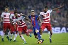 FC Barcelona's Lionel Messi, second right, duels for the ball against Granada's Mehdi Carcela Gonzalez, right, during the Spanish La Liga soccer match between FC Barcelona and Granada at the Camp Nou in Barcelona, Spain, Saturday, Oct. 29, 2016. (AP Photo/Manu Fernandez)