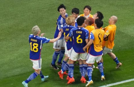 Japan's Takuma Asano celebrates after scoring during the World Cup group E soccer match between Germany and Japan, at the Khalifa International Stadium in Doha, Qatar, Wednesday, Nov. 23, 2022. (AP Photo/Petr Josek)