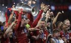 Liverpool's players celebrate with the trophy after winning the Champions League final soccer match between Tottenham Hotspur and Liverpool at the Wanda Metropolitano Stadium in Madrid on June 2, 2019. (AP Photo/Felipe Dana)