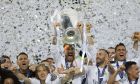 FILE - In this May 28, 2016 fiel photo, Real Madrid's Sergio Ramos raises the trophy after the Champions League final soccer against Atletico Madrid at the San Siro stadium in Milan, Italy. An emotional Sergio Ramos said goodbye to Real Madrid on Thursday, saying he wanted to stay but the club preferred not to renew his contract. (AP Photo/Manu Fernandez, File)