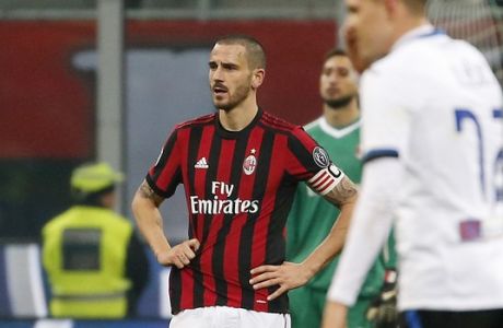 AC Milan's Leonardo Bonucci, left, stands on the pitch after Atalanta's Josip Ilicic scored his side's second goal during the Serie A soccer match between AC Milan and Atalanta at the San Siro stadium in Milan, Italy, Saturday, Dec. 23, 2017. (AP Photo/Antonio Calanni)