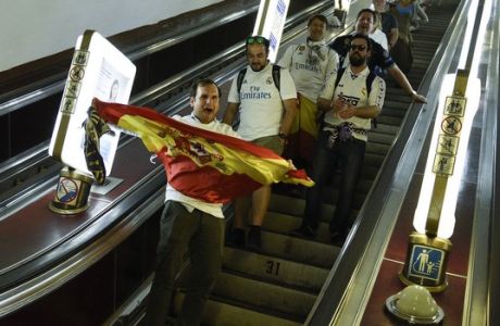 Real Madrid supporters react as they take an escalator on the metro in Kiev, Ukraine, Saturday, May 26, 2018. Supporters were gathering in Kiev ahead of the Champions League final soccer match between Real Madrid and Liverpool later Saturday. (AP Photo/Andrew Shevchenko)