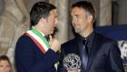 Former Argentina and Fiorentina striker Gabriel Batistuta, right, talks with Florence's mayor Matteo Renzi, after being awarded the "Hall of Fame" prize for his career, during a ceremony at Palazzo Vecchio in Florence, Monday, Dec. 2, 2013. (AP Photo/Francesco Bellini)