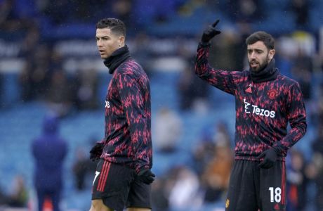 Manchester United's Cristiano Ronaldo, left, and Manchester United's Bruno Fernandes during warm up before the English Premier League soccer match between Leeds United and Manchester United, at Elland Road Stadium in Leeds, England, Sunday, Feb. 20, 2022. (AP Photo/Jon Super)