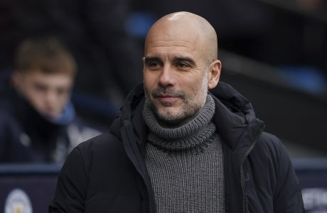 Manchester City's head coach Pep Guardiola smiles before the English Premier League soccer match between Manchester City and Wolverhampton at the Etihad Stadium in Manchester, England, Sunday, Jan. 22, 2023. (AP Photo/Dave Thompson)