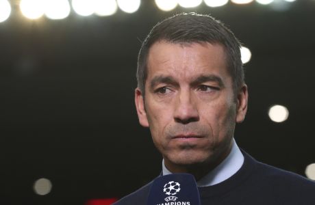 Rangers' manager Giovanni van Bronckhorst talks to a reporter before the Champions League group A soccer match between Rangers and Napoli at the Ibrox stadium in Glasgow, Scotland, Wednesday, Sept. 14, 2022. (AP Photo/Scott Heppell)