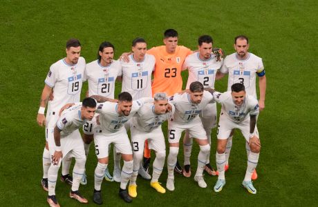 Uruguay's starting players pose for a photo prior a during the World Cup group H soccer match between Portugal and Uruguay, at the Lusail Stadium in Lusail, Qatar, Monday, Nov. 28, 2022. (AP Photo/Darko Vojinovic)