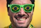SAO PAULO, BRAZIL - JUNE 12: A fan smiles while wearing glasses with Brazilian flag lenses during the Opening Ceremony of the 2014 FIFA World Cup Brazil prior to the Group A match between Brazil and Croatia at Arena de Sao Paulo on June 12, 2014 in Sao Paulo, Brazil.  (Photo by Christopher Lee/Getty Images)