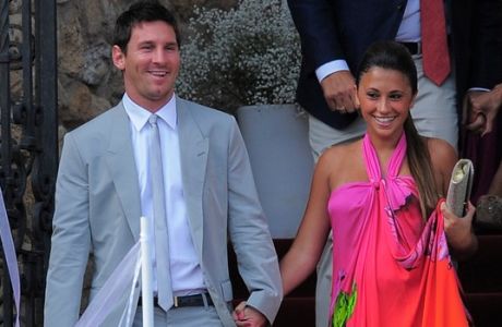 FC Barcelona's Lionel Messi, from Argentina, left, and his girlfriend Antonella Roccuzzo arrive to the Andres Iniesta's wedding at the castle of Tamarit in Tarragona, Spain, Sunday, July 8, 2012. (AP Photo/Manu Fernandez)