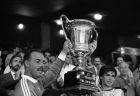 The Liverpool goalkeeper Bruce Grobbelaar, left, and captain Alan Hansen of the team hold the trophy of the Villa de Madrid after their victory 1-0 over the Atletico de Madrid on Sunday, August 23, 1987. Madrid's mayor Juan Barranco, left, stands by. (AP Photo/Toka)