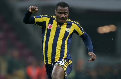 Galatasaray's Aurelien Chedjou, right, and Emmanuel Emenike of Fenerbahce fight for the ball during their Turkish League soccer derby match at the TT Arena stadium in Istanbul, Turkey, Saturday, Oct. 18, 2014.(AP Photo)
