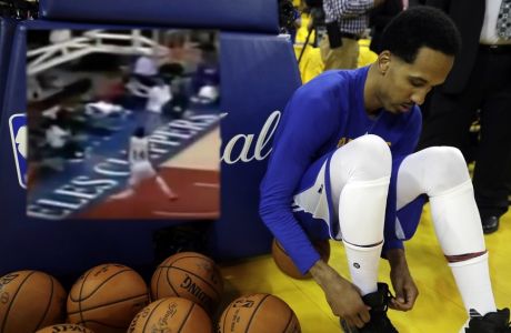 Golden State Warriors' Shaun Livingston ties his shoes as he prepares to warm up before Game 1 of basketball's NBA Finals against the Cleveland Cavaliers Thursday, June 1, 2017, in Oakland, Calif. (AP Photo/Marcio Jose Sanchez)