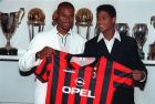 Dutch soccer players Winston Bogarde, left, and Patrick Kluivert, right, of Ajax, pose with their prospective team AC Milan jersey during a press conference at Milan's headquarters Friday, July 4, 1997. (AP Photo/Carlo Fumagalli)