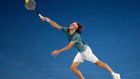 Greece's Stefanos Tsitsipas makes a forehand return to Switzerland's Roger Federer during their fourth round match at the Australian Open tennis championships in Melbourne, Australia, Sunday, Jan. 20, 2019. (AP Photo/Kin Cheung)