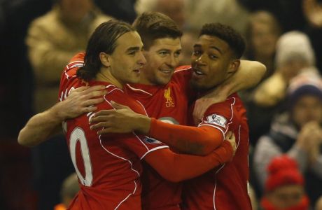 Liverpool's Steven Gerrard, center, celebrates scoring with teammates Lazar Markovic, left, and Jordon Ibe during the English Premier League soccer match between Liverpool and Tottenham Hotspur at Anfield Stadium, Liverpool, England, Tuesday Feb. 10, 2015. (AP Photo/Jon Super)