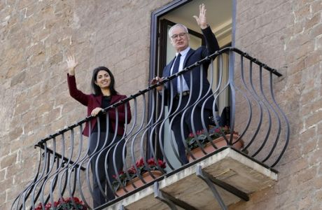 Coach Claudio Ranieri, right, is flanked by Rome's Mayor Virginia Raggi as they wave from a balcony of Rome's Capitol Hill, Thursday, March 30, 2017 after Ranieri received an honorary award for his work at Leicester City. (AP Photo/Andrew Medichini)