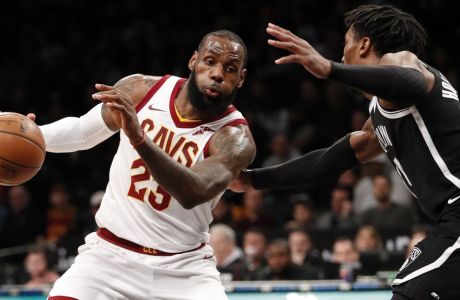 Cleveland Cavaliers forward LeBron James, left, drives around Brooklyn Nets forward Rondae Hollis-Jefferson, right,  during the first half of an NBA basketball game, Sunday, March 25, 2018, in New York. (AP Photo/Kathy Willens)