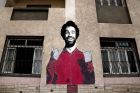 This May 2, 2018 photo, shows a wall mural of Mohamed Salah at a sports and youth center, in the Nile delta village of Nagrig, Egypt. Residents boast of how the Liverpool winger has poured millions of pounds into the village, with the beneficiaries list including a school, a mosque, a youth center and a dialysis machine at a nearby hospital. His success as a footballer in Europes most attractive league has inspired many parents in Nagrig to send their children to soccer academies in the hope that maybe one day they can emulate his success. (AP Photo/Nariman El-Mofty)