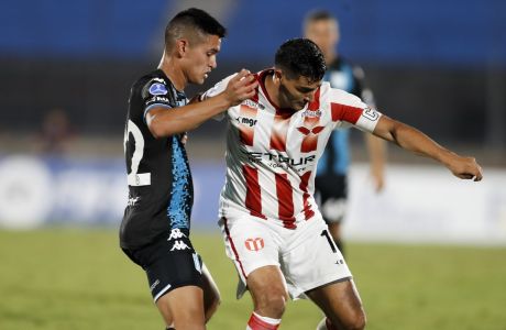 Gonzalo Castro of Uruguay's River Plate, right, and Carlos Alcaraz of Argentina's Racing Club battle for the ball during a Copa Sudamericana soccer match in Montevideo, Uruguay, Thursday, April 7, 2022. (AP Photo/Matilde Campodonico)