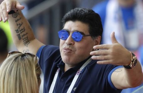 Argentinian soccer legend Diego Armando Maradona waves to visitors during the round of 16 match between France and Argentina, at the 2018 soccer World Cup at the Kazan Arena in Kazan, Russia, Saturday, June 30, 2018. (AP Photo/Sergei Grits)